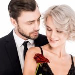 Happy couple of man and woman in black standing together