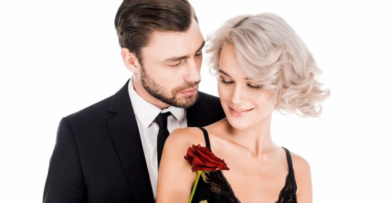 Happy couple of man and woman in black standing together