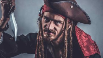 Pirate man with long hair holding a knife