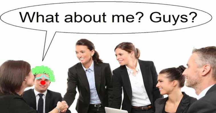 Office meeting men and women in suit a guy looks like clown with red nose and green hair