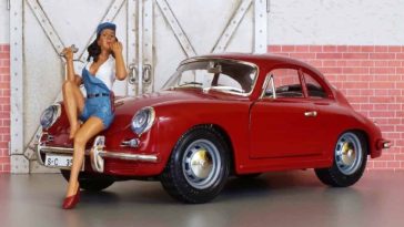 Classic red porsche 911 toy with a toy doll standing in front