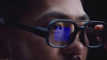 Asian brunette man with mustache wearing black Xiaomi Smart Glasses