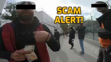 Street scammer holding money in his hand