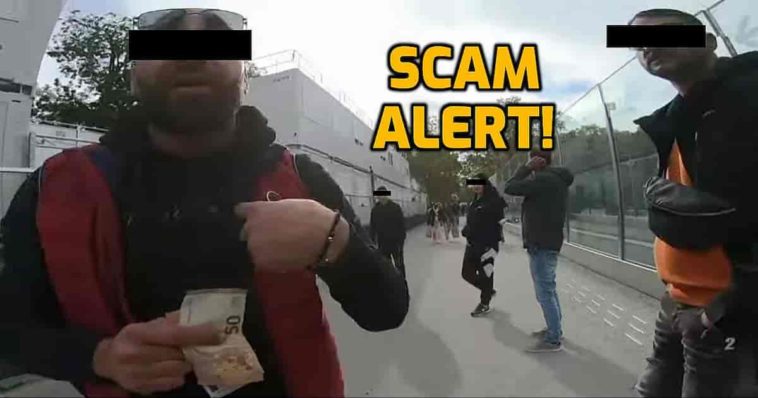 Street scammer holding money in his hand